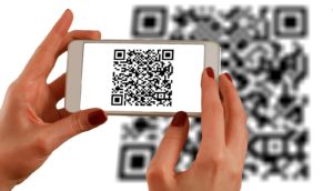 A person scanning a QR Code using a smartphone - QR codes are an ideal way to get more reviews